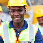 A group of construction workers wearing hard hats.