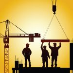 Three men standing on a building site holding up beams.