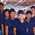 A group of people in blue shirts and hats.