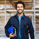 A man holding a hard hat in his hand.