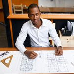 A man sitting at a table with some plans