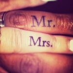 Couple's "Mr." and "Mrs." finger tattoos.