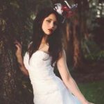 Bride in white dress with hat.