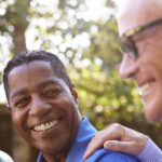 Two happy senior men enjoying friendship outdoors.